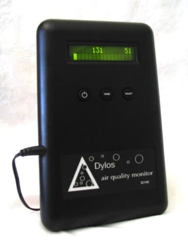 Dylos DC1100 Pro air quality monitor, a small black desktop unit with an LCD particle count display